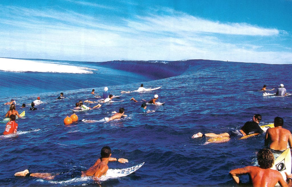 Teahupoo wave and its surfers