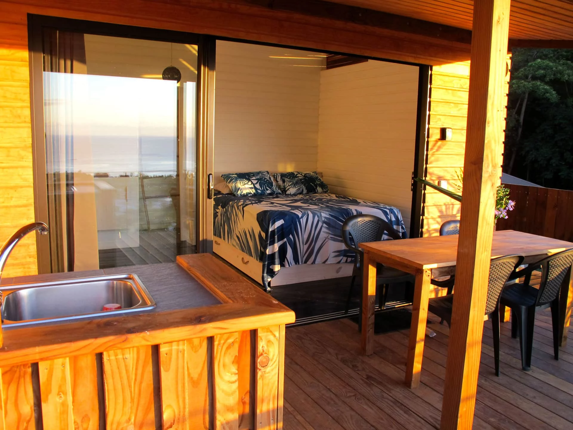 bungalow aito with exterior view of the bungalow featuring a kitchen, dining area, and bedroom with a double bed