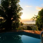 bounty lodge pool of bungalows and terrace with ocean view at the sunset