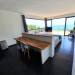Villa Bounty king size bed and desk of the master suite with ocean view