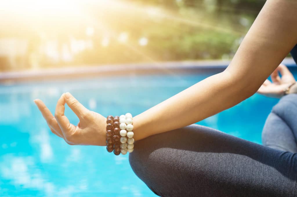 Woman meditating in yoga in a lotus position at the bounty lodge