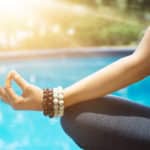 Woman meditating in yoga in a lotus position at the bounty lodge